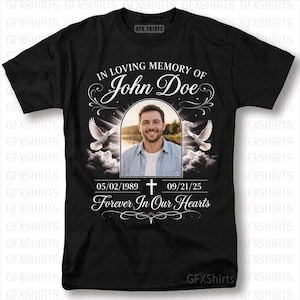 May include: Black t-shirt with a memorial design. The shirt features the text "IN LOVING MEMORY OF John Doe" above a photo of a man. Below the photo are the dates 05/02/1989 - 09/21/25 and the words "Forever In Our Hearts".