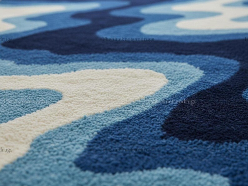 Hand-tufted wavy pattern rug in an irregular organic shape; ocean blue to navy blues with white cream, a textured plush melting rug.