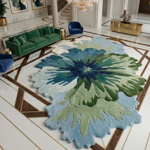 May include: A large, floral-shaped rug in shades of blue, green, and white. The rug's design resembles a stylized flower, with layered petals in varying tones. The rug is placed on a tiled floor with a geometric pattern. The rug is a focal point.