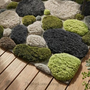 Modern hand-tufted beige wool rug with pebble pattern on balcony; 3D textured abstract carpet in gray, black, moss green.