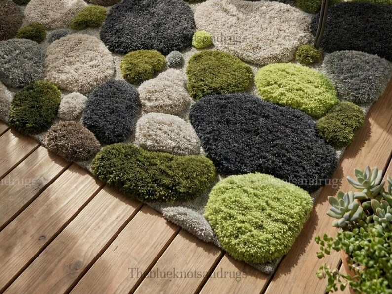 Modern hand-tufted beige wool rug with pebble pattern on balcony; 3D textured abstract carpet in gray, black, moss green.