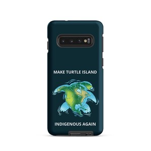 May include: A dark teal phone case featuring the text "MAKE TURTLE ISLAND" above an illustration of a turtle-shaped map of the world. The text "INDIGENOUS AGAIN" is below the map. The case has a camera cutout at the top.