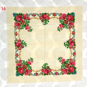 Op de afbeelding: Vierkante cr&egrave;mekleurige sjaal met een bloemenmotief. De rand heeft rode rozen, groene bladeren, blauwe accenten en goudkleurige versieringen. Het nummer "16" staat in de linkerbovenhoek.