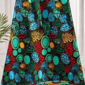 May include: A fabric featuring a repeating pattern of rounded, pebble-like shapes in vibrant shades of turquoise, blue, red, and yellow against a solid black background. The shapes display varied internal textures, including dotted and webbed designs.