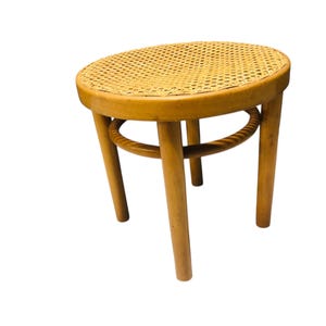 Low blonde vintage stool in Thonet style, retro mid-century stool from the 80s with a webbing seat