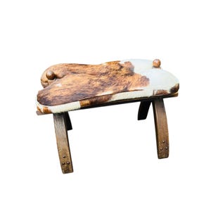 Vintage footstool made of cowhide, wooden sixties camel saddle made of cowhide