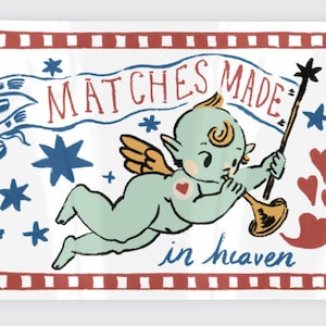 May include: A sticker featuring a vintage-style illustration of a cherubic figure with wings, holding a trumpet and a star-tipped wand. The text "MATCHES MADE in heaven" is displayed above and below the cherub, with stars and hearts.