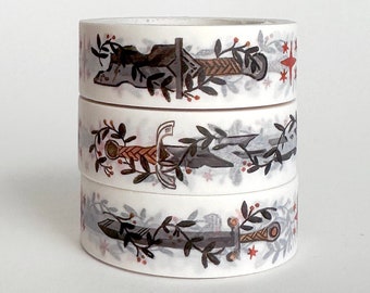 May include: Three rolls of washi tape with a white background and a repeating pattern of swords with vines and red berries.