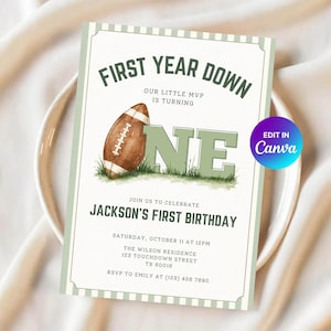 May include: A rectangular birthday invitation card with a white background and light green striped border. It features a brown football, the text FIRST YEAR DOWN, OUR LITTLE MVP IS TURNING ONE, JACKSON'S FIRST BIRTHDAY, and event details.
