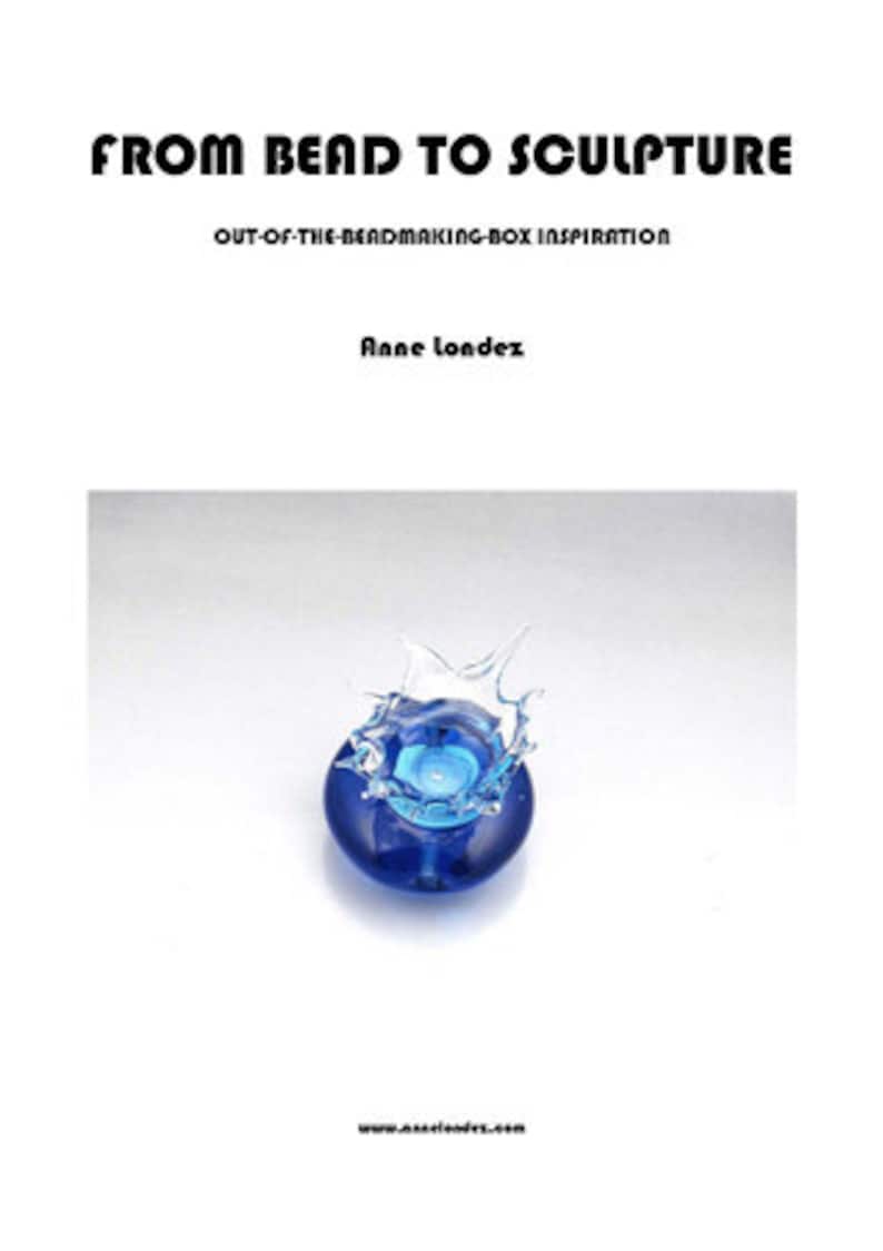 K&ouml;nnte beinhalten: Buchcover mit dem Titel "FROM BEAD TO SCULPTURE" und dem Untertitel "OUT-OF-THE-BEADMAKING-BOX INSPIRATION" von Anne londez. Das Bild zeigt eine blaue Glasskulptur mit Spritzeffekt. Die Website www.annelondez.com befindet sich unten.