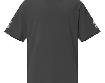 May include: A charcoal gray short-sleeve t-shirt with a crew neckline. The sleeves feature a small, light gray graphic design on the outer edges. The shirt is constructed with a standard fit and a solid, dark-toned fabric throughout the body.