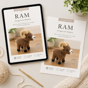 May include: An amigurumi crochet pattern for a ram displayed on a tablet and a printed sheet. The ram is brown with tan horns and a white face. The text on the pattern reads "RAM Amigurumi Pattern" and "Easy to Follow."