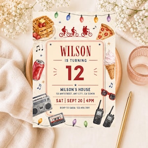 May include: A rectangular birthday invitation card featuring watercolor illustrations of waffles, pizza, a soda can, a boombox, cassette tape, walkie-talkies, and sunglasses. Text reads: WILSON IS TURNING 12, WILSON'S HOUSE, 123 ANYSTREET, ANY CITY, CA 123456, SAT | SEPT 20 | 4PM, RSVP TO SARA: 123.456.7891.