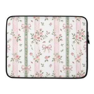May include: Laptop sleeve featuring a floral pattern with pink roses, bows, and green accents on a white background. The design includes vertical stripes of pink polka dots and green ribbons, creating a romantic and feminine aesthetic.