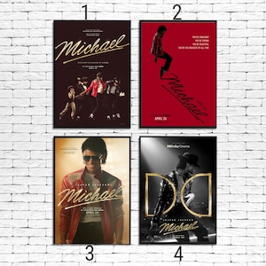 May include: Four framed posters featuring Michael Jackson. The posters have different designs, including images of Michael Jackson in various poses and outfits. The posters are against a white brick wall. The posters have the word "Michael" in gold script.