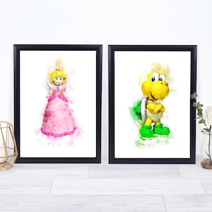May include: Two framed watercolor prints featuring characters from a video game. One print shows a princess in a pink dress, and the other depicts a turtle-like character in green and yellow. The prints are in black frames.