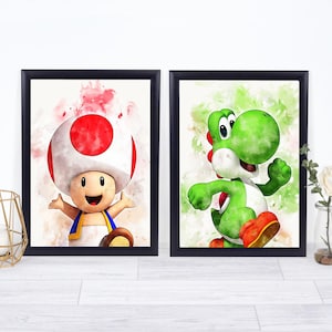 May include: Two framed watercolor prints featuring characters from the Super Mario video game series. One print showcases Toad with a red and white mushroom cap, and the other features Yoshi, a green dinosaur-like character.