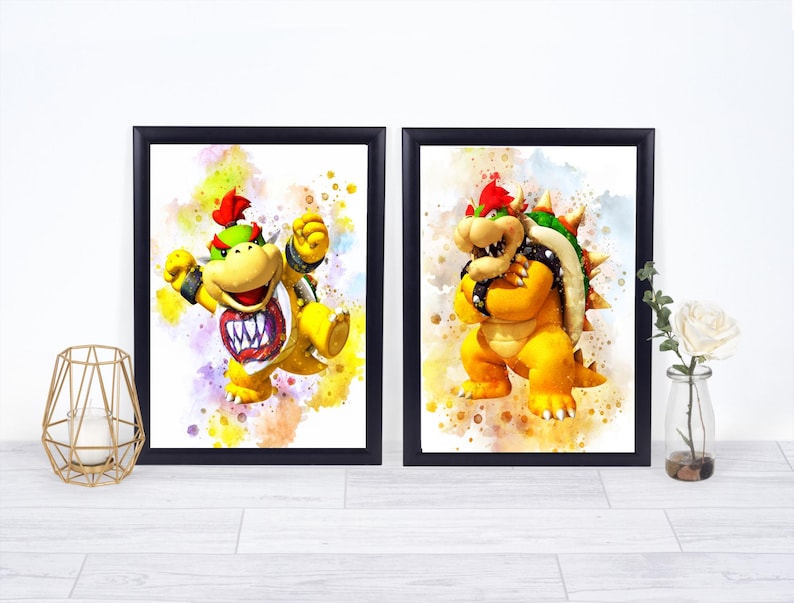May include: Two framed watercolor prints featuring Bowser Jr. and Bowser from the Super Mario series. The characters are depicted in vibrant yellow, green, and red hues against a colorful splatter background. The frames are black.