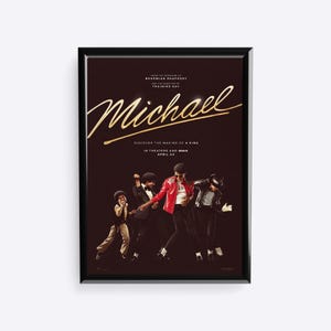 May include: Framed movie poster for "Michael" with a dark brown background. The title "Michael" is in gold script. The poster features images of Michael Jackson in various outfits, dancing. Text includes "Discover the Making of a King" and "In Theaters and IMAX April 24."