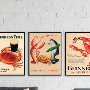 May include: Three framed vintage Guinness and seafood posters. One shows a crab with a pint of Guinness, another a lobster with a magnifying glass, and a fish with a cucumber. Text includes "Guinness Time" and "My Goodness".