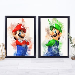 May include: Two framed watercolor prints featuring Mario and Luigi from the Super Mario Bros. series. Mario is in a red hat and shirt, blue overalls, and Luigi is in a green hat and shirt, blue overalls. Both have their arms crossed.