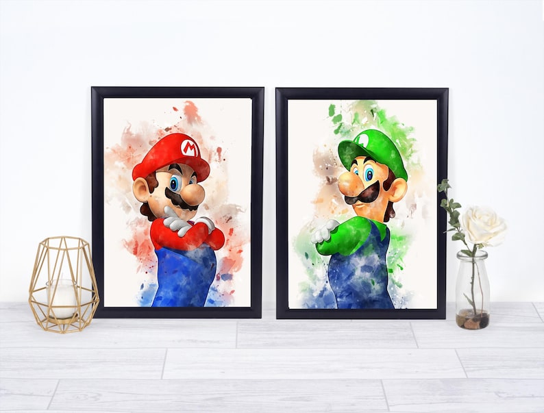 May include: Two framed watercolor prints featuring Mario and Luigi from the Super Mario Bros. series. Mario is in a red hat and shirt, blue overalls, and Luigi is in a green hat and shirt, blue overalls. Both have their arms crossed.