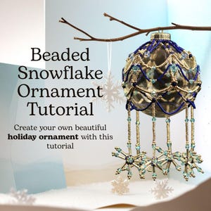 May include: A decorative beaded snowflake ornament, with blue and gold beading, hangs from a branch. The text reads "Beaded Snowflake Ornament Tutorial". The ornament has dangling snowflake accents.