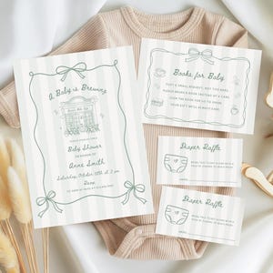May include: A baby shower invitation set featuring a coffee shop illustration and the text A Baby is Brewing, Books for Baby, and Diaper Raffle. The stationery has a light green striped pattern with bow accents, displayed on a beige ribbed bodysuit.
