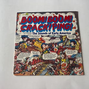 May include: A vintage record album cover with a cartoon illustration of people in colonial garb. The album title is "BOOM! BOOM! CRACK!PING! The Sounds of Early America".