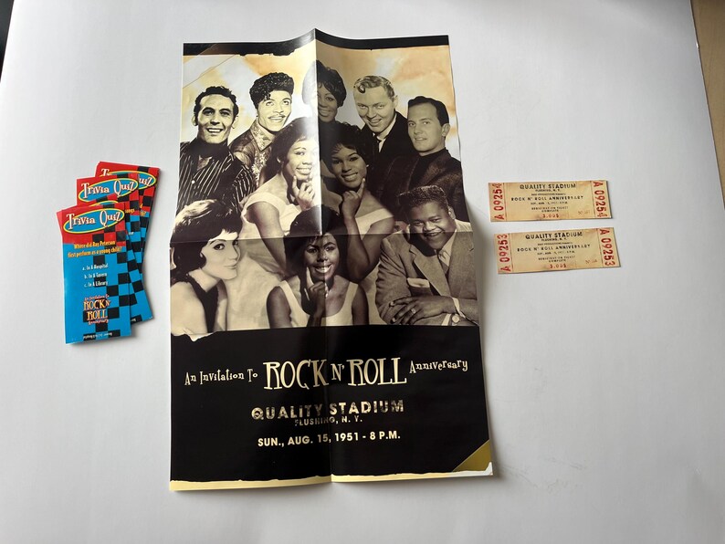 May include: A black and white poster advertising a Rock 'n' Roll Anniversary at Quality Stadium in Flushing, NY on August 15, 1951. The poster features a group of people, including singers and musicians, with the text "An Invitation to Rock 'n' Roll Anniversary" and "Quality Stadium Flushing, N.Y. Sun., Aug. 15, 1951 - 8 P.M."