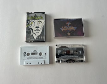 May include: Three cassette tapes, two are black and one is white. The black tapes have the band name "Winger" printed on them. The white tape has the text "Winger - In the Heart of the Young" printed on it.