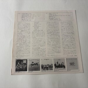 May include: A vintage record album cover with Japanese text and images. The cover features a list of songs and lyrics, along with several small images of the band. The album is on a white background.
