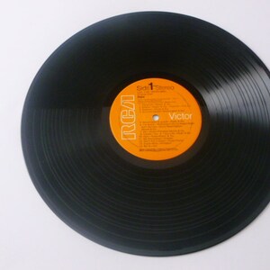 May include: Black vinyl record with an orange label that says "RCA Victor" and "Side 1 Stereo".