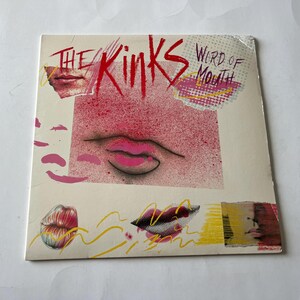 May include: A pink and white album cover with the text "The Kinks Word of Mouth" in black and white. The cover features a pink and white illustration of a mouth with pink lips.