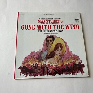 May include: A vintage vinyl record album cover featuring a color illustration of a man and woman in period clothing. The album is titled "Gone With The Wind" and features the composer Max Steiner's name and the London Symphony Orchestra.