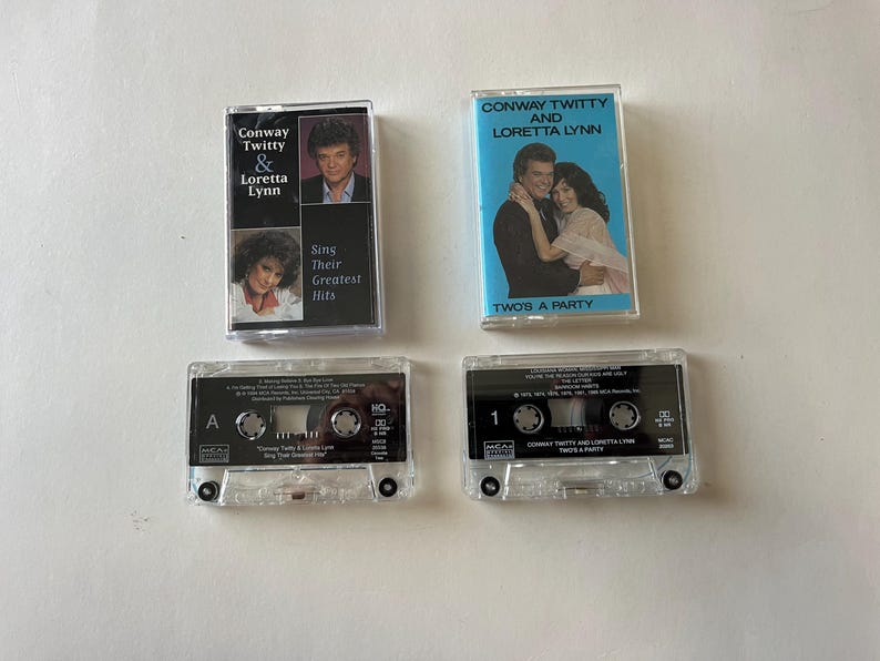 May include: Four cassette tapes featuring Conway Twitty and Loretta Lynn. The tapes are labeled "Sing Their Greatest Hits" and "Two's A Party".