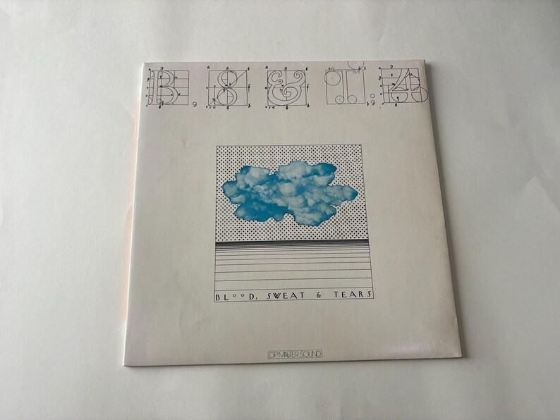 May include: Album cover for "Blood, Sweat & Tears" featuring a blue cloud graphic on a white background. The album title is printed in black, with a grid pattern and horizontal lines. The top has architectural drawings.