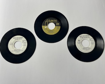 May include: Three black vinyl records with gold labels. The labels feature the text "MCA Records" and the names of the songs "Searchin' Circles", "Beyond the Milky Way", and "In a Garden or a Zoo".