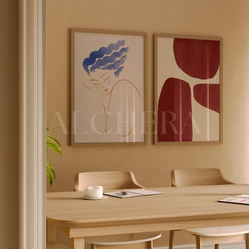 2 Vertical Frame Video Mockup in warm earthy dining room setting featuring thin wood framed artwork – an abstract red shape and a minimalist blue-haired portrait. Ideal for PSD Photoshop users looking for a high quality mockup DIN A ratio. Perfect as a frame mockup video, poster mockup video, or reel mockup video. This interior mockup scene is designed to highlight vertical frame artwork mockup and single frame mockup visuals for creatives and designers.
