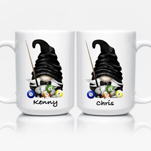 May include: Two white ceramic mugs featuring a gnome design with a black hat, bow tie, and a pool cue. Each mug has a different name at the bottom, with colorful pool balls. The mugs are perfect for a billiards enthusiast.