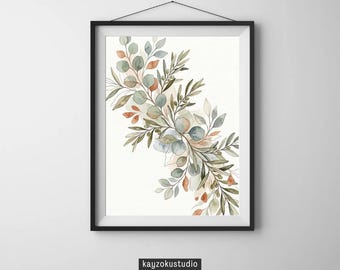 Op de afbeelding: Een ingelijste aquarelprint met een botanisch ontwerp. Het kunstwerk toont een verzameling groene, blauwe en oranje bladeren en takken. De print zit in een zwart frame en hangt aan een witte muur. De tekst "kayzokustudio" staat onderaan.