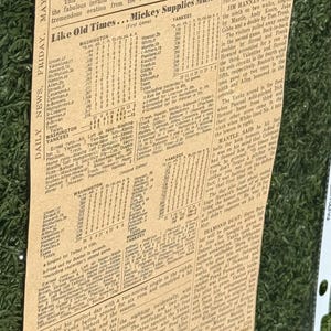 May include: A newspaper clipping from May 31, 1968, with the headline "Mick's 5-for-5, 2 HRs Win." The article details Mickey Mantle's performance in a baseball game, including two home runs. The text is in black ink on aged newsprint.