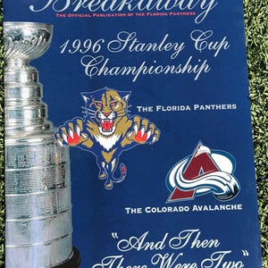 May include: A blue magazine cover with the text "Breakaway" and "1996 Stanley Cup Championship." Features the Florida Panthers logo and the Colorado Avalanche logo. The Stanley Cup trophy is visible on the left side. The text "And Then There Were Two" is at the bottom.