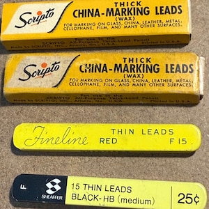 May include: Three vintage boxes of writing leads. Two yellow boxes read "Scripto CHINA-MARKING LEADS" and one reads "Fineline RED THIN LEADS". The fourth box reads "SHEAFFER 15 THIN LEADS BLACK-HB (medium)".
