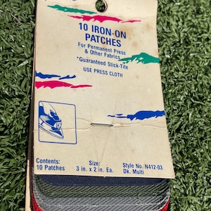 May include: A package of ten iron-on patches in various colors, including red, gray, and green. The package reads "10 Iron-On Patches" and "Guaranteed Stick-Tite." Each patch measures 3 inches by 2 inches.