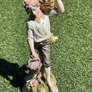 Vintage 9.5” Porcelain Figurine – Barefoot Young Man with Grapes & Basket of Fruit – Hand-Painted Pastel Accents