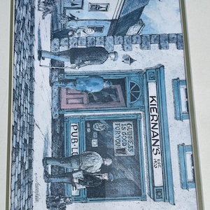 May include: An artistic print of Kiernan's Pub, with the text "Guinness is good for you!" and "Pub-Lo". The illustration depicts people outside the pub, with a blue and white color scheme. The pub's name and establishment year, 1970, are also visible.