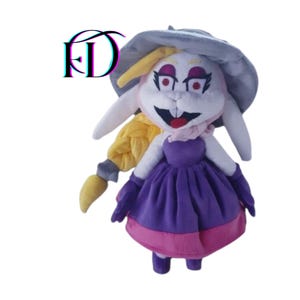 May include: A plush toy of a white rabbit character wearing a purple dress with a pink hem, purple gloves, and shoes. The rabbit has a gray hat, a yellow braid, and a pink scarf. The character has red eyes and a wide smile.