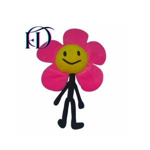 May include: A plush flower toy with a smiling yellow center and pink petals. It has black arms, legs, and a stem. The toy is designed to resemble a flower with a friendly face. The logo "FD" is in the upper left corner.