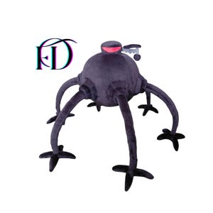 May include: A plush, dark gray, robotic-looking creature with six long legs and a rounded body. The top of the body has a red accent and a small, silver-colored detail. The legs end in a black, star-shaped foot.